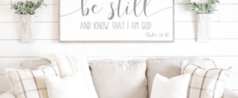 Image of white couch with sign above saying "be still and know that I am God Psalm 46:10"